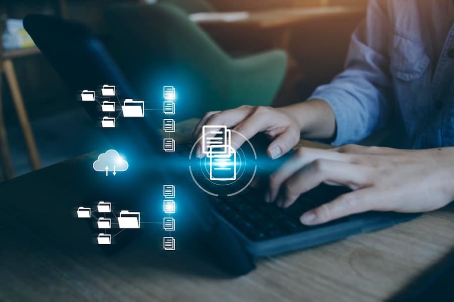 Person working at computer with floating digital storage icons, illustrating our immutable storage capabilities for data integrity. Person working at computer with floating digital storage icons, illustrating our immutable storage capabilities for data integrity.